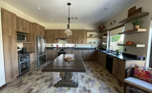 This kitchen checks all the boxes of warmth and texture. This space features Wellborn's aspire frameless cabinetry, Bedrosian porcelain floor, and bohemian flame countertops. [TWD Project Location: Peoria, AZ]