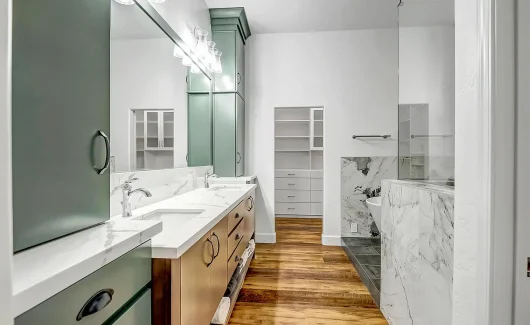 A stunning double-sink vanity designed perfectly for this couple’s ensuite. Featuring two-tone cabinet design with Painted Sage and Maple Latte finishes, this vanity brings character and a timeless feel to this space.