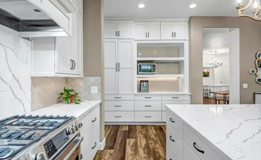 This gorgeous kitchen remodel incorporates floor-to-ceiling cabinetry from Wellborn Cabinet, Inc. creating a highly functional space with enhanced storage and organization.
