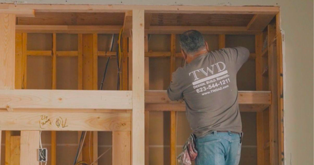 Planning a custom media wall in a Phoenix home with framing in progress